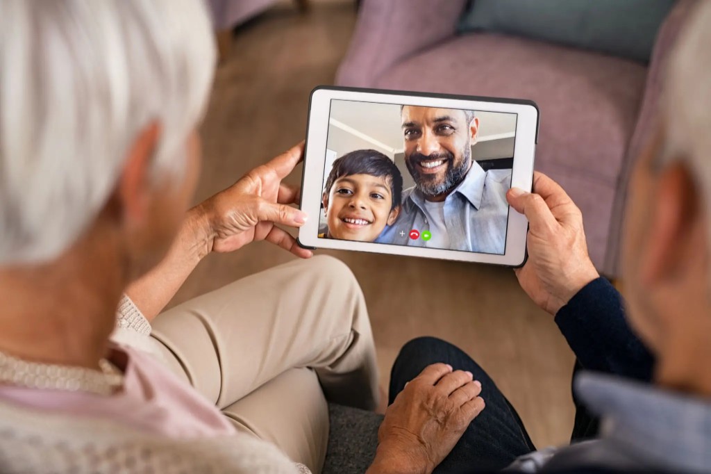 Grandparents on a video call with their son and grandchild via BondNow